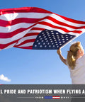 Woman holding All American Patriotic 3x5 Ft Outdoor Flag With Brass Grommets for porch, gardens, and home decor, clear sky background.