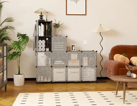 12 Cube Storage Organizer With Doors For Bedroom And Living Room DIY Plastic Closet Shelf Modular Bookshelf Stackable Cube Shelving Rack Black Dope Easy Assembly For Apartment Living And Home Organization displayed in a living room setting, holding books and decor items.