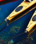 Elastic Dock Line With Metal Hook And Loop Ends 48 Inches mooring yellow kayaks on clear water, close-up view.