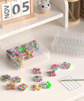 Clear Bead Organizer Storage Box Set With 31 Hinged Lid Containers for small parts on a table, showcasing open compartments filled with colorful beads.