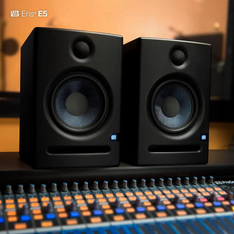 Two Way 5.25 Inch Near Field Studio Monitors with Silk Dome Tweeter and 80 Watt Class AB Power on a mixing desk
