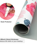 Close-up of rolled Large Pink Floral Desk Pad For Computer And Gaming Setup 31.5 Inch By 15.7 Inch Waterproof PU Leather