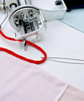 5 Pack Needle Threaders for Hand Sewing and Machine Threading with red thread, steel wire, used in textile machine setup.