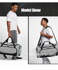 Man carrying Built Tough 55L Duffle Bag For Men Large Gym Duffel For Workout Sports And Travel Gear Gray with shoulder strap and handles