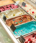 Six Pack 1/3 Size Stainless Steel Steam Table Pans 2.5 Inch Deep Hotel Pan Trays For Buffet And Catering filled with colorful ice creams