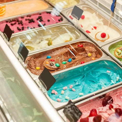 Six Pack 1/3 Size Stainless Steel Steam Table Pans 2.5 Inch Deep Hotel Pan Trays For Buffet And Catering filled with colorful ice creams