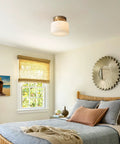 Modern Brushed Gold Semi Flush Drum Ceiling Light Fixture With Milk Glass Shade in a cozy bedroom setting