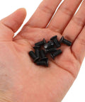 Hand holding Black Stainless Steel Front Shock Absorber Screw Set For Electric Scooters Pro Grade Torque Calibrated Secure Installation Includes Hex Key Premium Maintenance Hardware Replacement.
