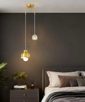 IPEDWO 2-Light Modern Gold Pendant Lights hanging in a bedroom, featuring a crystal and gold design with two light sources.