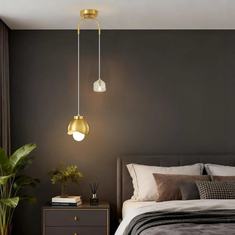 IPEDWO 2-Light Modern Gold Pendant Lights hanging in a bedroom, featuring a crystal and gold design with two light sources.