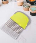 Crinkle cutter knife with yellow silicone handle and stainless steel blade for slicing potatoes and veg front view