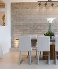 Dining room with Norris 4-Light Track Lighting in Oil Rubbed Bronze With Champagne Glass Heads over modern table.