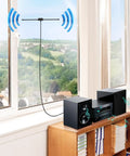 Indoor FM Dipole Antenna For Stereo Receivers And Home Theater Systems, 75 Ohm Unbalanced, mounted on window, enhancing signal