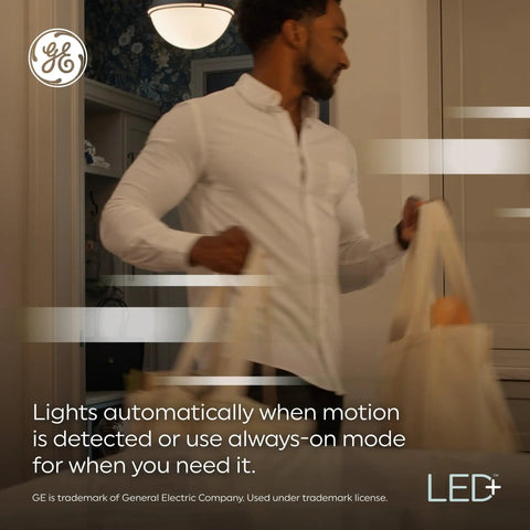 Man carrying bags under Motion Sensor LED Bulbs 12W A21 Outdoor Security Lighting Warm White 2 Pack Auto On With Motion Detection