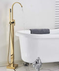 Solid Brass Freestanding Bathtub Faucet With Hand Shower in Gold Polished Finish beside white clawfoot tub