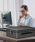 Beefy Fireproof Document Box Hard Case With Fireproof Zipper And Lock on desk, shown with woman at computer, black color