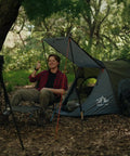 Pop Up One Person Tent With Instant 3 Second Setup Waterproof Outdoor Shelter in forest, man sitting outside in chair