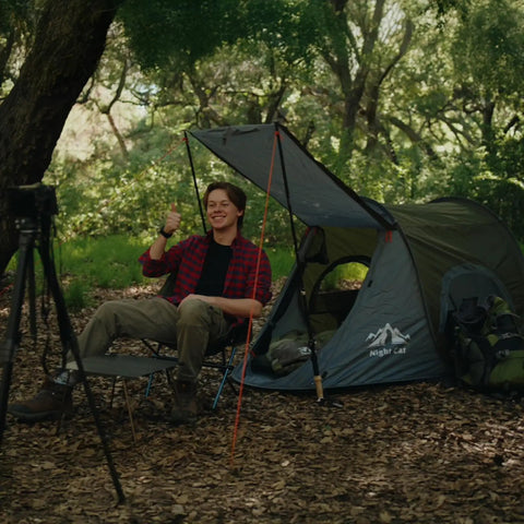 Pop Up One Person Tent With Instant 3 Second Setup Waterproof Outdoor Shelter in forest, man sitting outside in chair