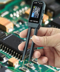 Close-up of 101A SMD Tester with Auto ID Pro Grade Portable Digital Multimeter being used for PCB repair, measuring capacitance