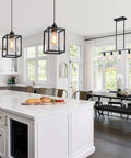 Rock Solid Black Pendant Lights For Kitchen Island, 3 Pack above a modern kitchen island with white cabinetry.