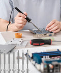 Person using a soldering iron with 7 Types TS100 Soldering Iron Tips Replacement Kit for Mini Digital Soldering Irons displayed below.