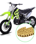 Image of a dirt bike with a 134 Link Drive Chain For 2 Stroke Dirt Bikes And Pocket Rockets, displaying a detailed view of the gold chain.