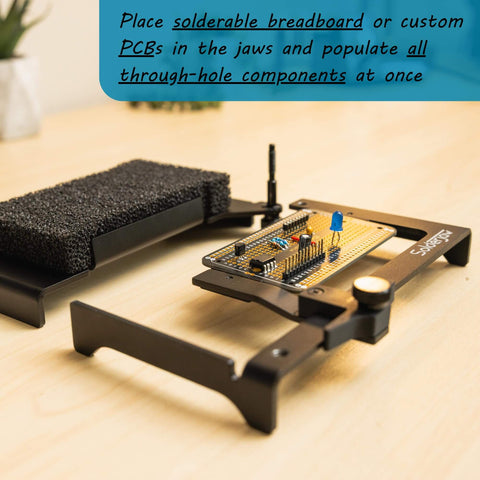 Hands Free Through-Hole Soldering Jig For PCBs And Breadboards CSJ-1 holding a PCB with components on a wooden desk.