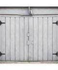 2 Pack 8 Inch T Strap Shed Door Hinges Black Tee Hinge fitted on a gray barn door, showing heavy-duty solid steel construction.