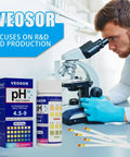 Scientist using microscope with PH Test Strips For Urine And Saliva With 200 Strips for home pH check, range 4.5 to 9.0 displayed.