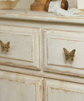2 Pack Butterfly Cabinet Knobs In Gold Pewter With Delicate Wings And Lifelike Antennae Bringing Whimsical Vibes To Girls Room Dresser Vanity Hardware on a white dresser.