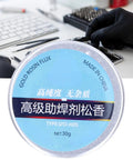 Person using High Purity Rosin Soldering Flux Paste for Electronics No Clean 30g Low Smoke No Mess Works Like a Charm for Mobile Phones Computers and PCB Repairs Keeps Soldering Smooth and Oxidation Free in blue jar during electronics repair