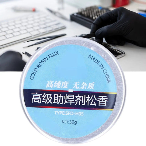 Person using High Purity Rosin Soldering Flux Paste for Electronics No Clean 30g Low Smoke No Mess Works Like a Charm for Mobile Phones Computers and PCB Repairs Keeps Soldering Smooth and Oxidation Free in blue jar during electronics repair