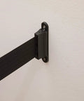 Crowd Control Wall Mount Barrier With 8 Foot Black Retractable Belt, Safe Braking System, wall installation close-up