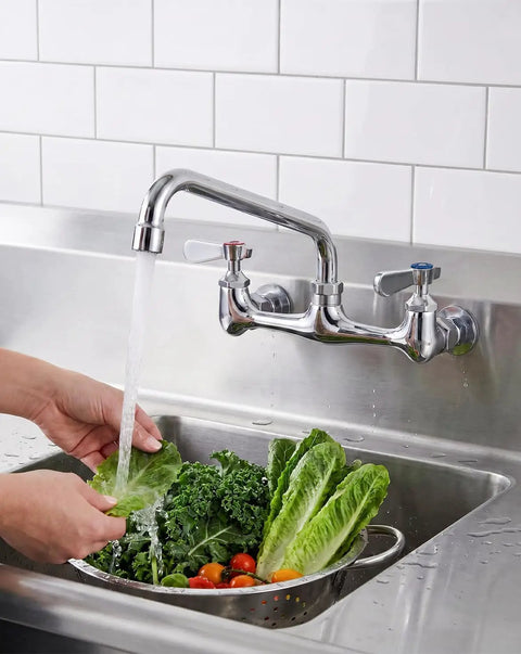 Lead-Free 8 Inch Center Wall Mount 3 Compartment Sink Faucet with 8" Spout washing greens in a utility sink.