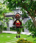 Cute ladybug on swing in garden, featuring Solar Powered Ladybug Swing Garden Decor Waterproof Metal Hanging Lights. Daytime view