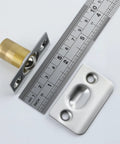 Close-up of Two Pack Go-To Adjustable Ball Catch Closet Door Latches in silver finish with brass pin, shown with ruler.