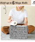 Woman placing toilet paper in Toilet Paper Storage Basket With Lid Made From Water Hyacinth Wicker Holds Up To 6 Mega Rolls