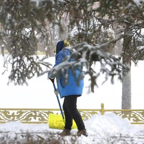 Person shoveling snow using Spade Handle Replacement For Snow Shovels With 32mm Inner Diameter Plastic D Grip Style, yellow handle