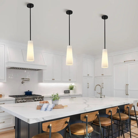 Ziikopoo 2 Pack Modern Matte Black Kitchen Island Pendant Lights, Conical Ribbed Glass Shade above marble countertop in kitchen.