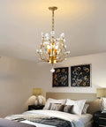 Three Light K9 Crystal Pendant Chandelier In Gold, Modern Glam Ceiling Light For Bedroom, shown with lit bulbs, 13 inch diameter
