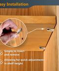 Rock Solid 1/4 Inch Spoon Shelf Pins 200 Pack Premium Stainless Steel Nickel Plated Pegs being installed in a wooden shelf.