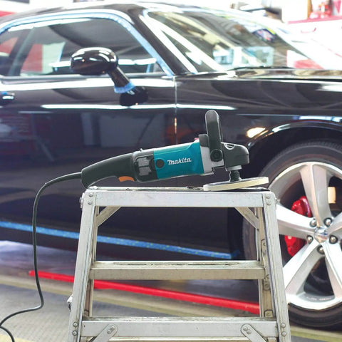 7-Inch Polisher, blue body, rubberized handle, on metal stepladder, with car background for auto detailing use