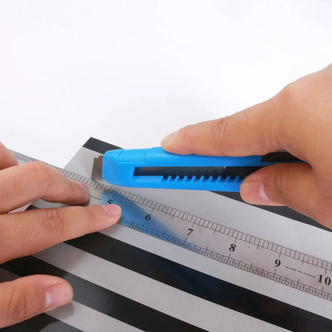 Using a utility knife from the 40 Piece All Purpose Tool Kit For Home Garage Office And Dorm Use Durable DIY Ready Handyman Set measuring with a ruler