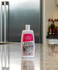 Real Deal Carnauba Wax Kitchen And Bath Polish Removes Scratches Stains Water Spots Protects Fiberglass Marble Acrylic Ceramic Chrome Stainless Steel 16 Oz Jar on a kitchen counter.