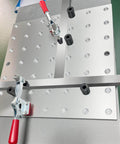 5/8 Inch Insert Clamp Fixture for Welding Tables on benchtop with quick press clamp and sliding jaws, mounted setup visible