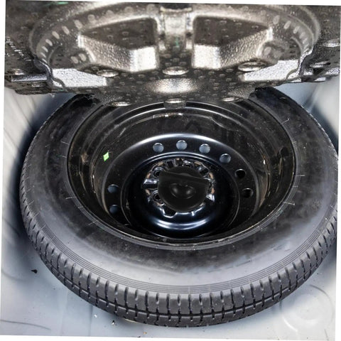 Spare Tire Bolt Retainer Clamp For Trailer And Car, Hold Down Bolt Keeps Spare Wheel Stable, Easy Install, Sturdy Material For Reliable Wheel Replacement And Quiet Trunk Rattle Prevention, shown securing spare tire in trunk.