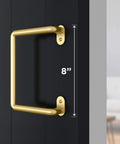 Troy Pull Handle N700-105 For Interior Sliding Barn Doors 8 Inch Brushed Gold Finish installed on a wood door.