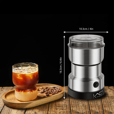 Electric Coffee And Spice Grinder Handheld 150W Quick Grinding With Stainless Steel Blades next to a glass of iced coffee