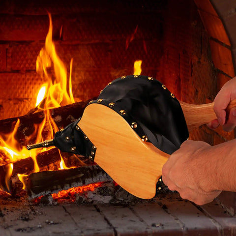 Heavy Duty 19 Inch Fireplace Bellows For Home And Camp being used to blow air into a fire, showcasing wood and zinc nozzle.