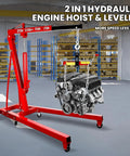 Rock Solid Engine Hoist And Folding Hydraulic Crane Featuring Six Low Friction Casters Built In Leveler Tilt Control And Heavy Duty Steel Shop Workhorse Handling 2 Ton 4400 Lbs Loads in a shop setting with an engine.